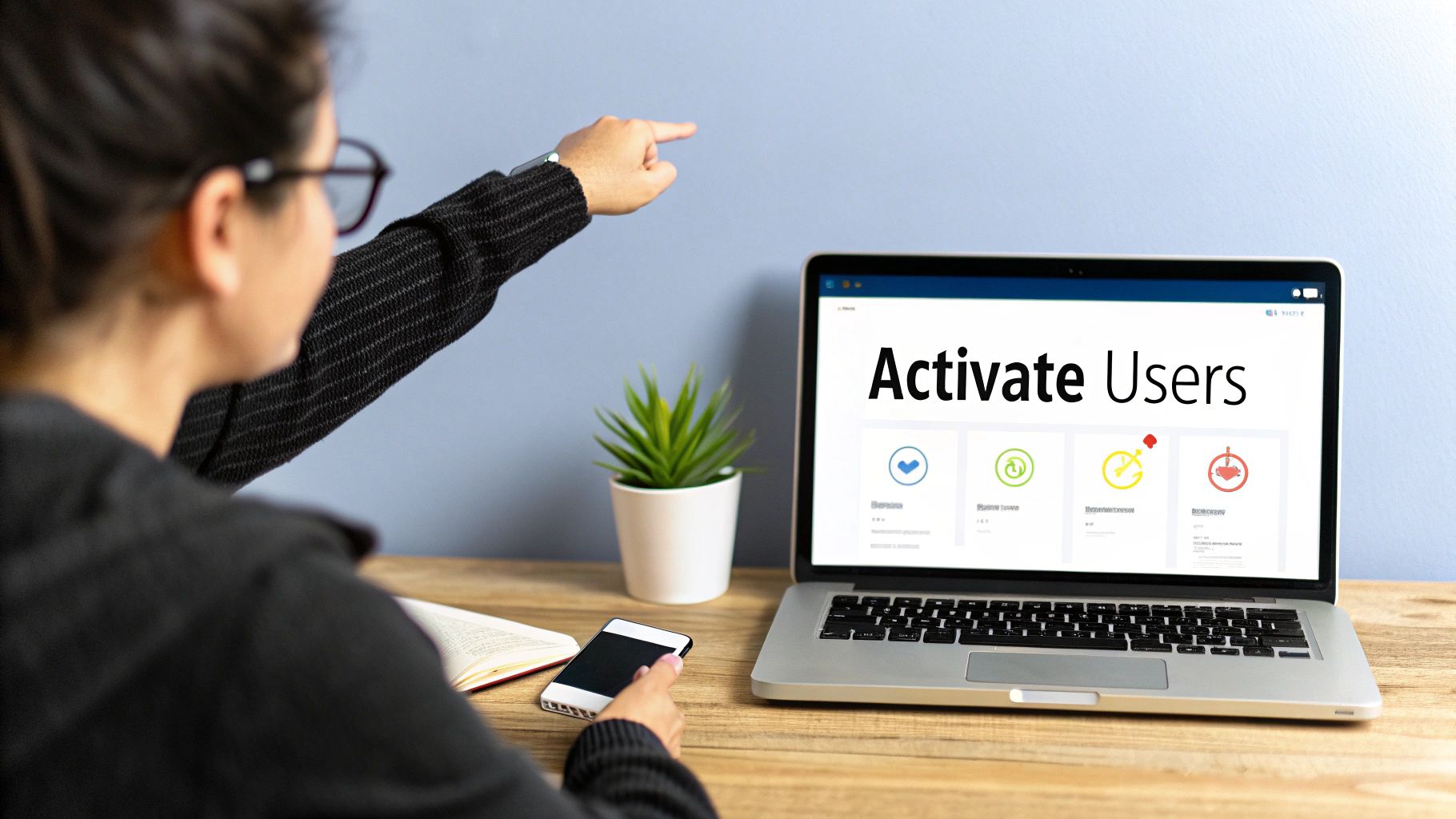 Person pointing at a laptop screen displaying 'Activate Users' and engagement metrics.