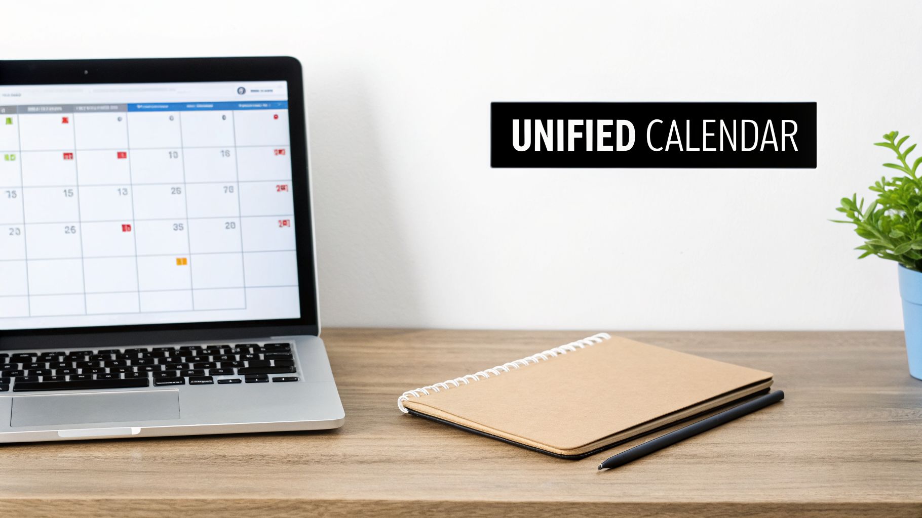 Laptop displaying a unified digital calendar with a notebook, pen, and plant on a wooden desk.
